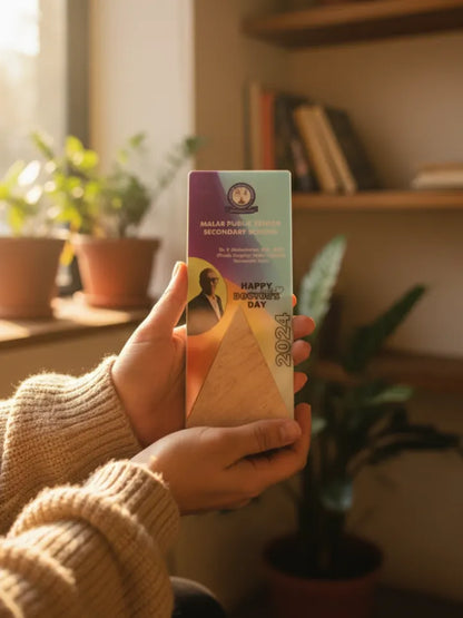 Person holding a box with a colorful design in a home setting