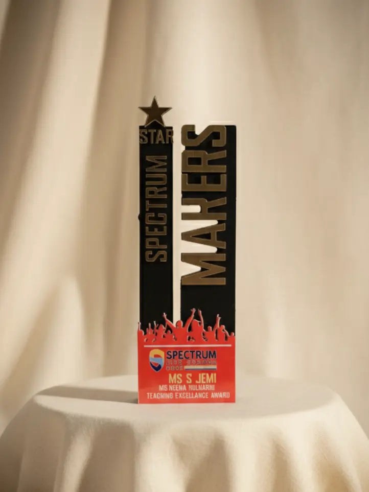 Spectrum Makers award with red base on a beige background