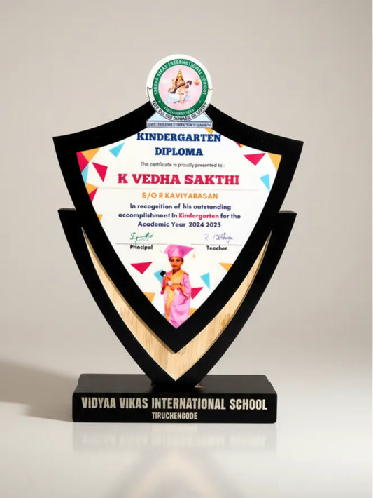 Academic award with a kindergarten diploma on a black stand, featuring 'Vidya Vikas International School' on a light gray background.