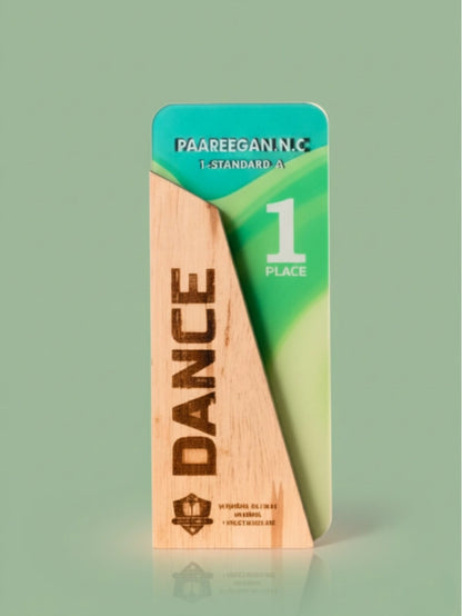 Wooden plaque with 'DANCE' engraved on it, awarded 1st place, on a green background