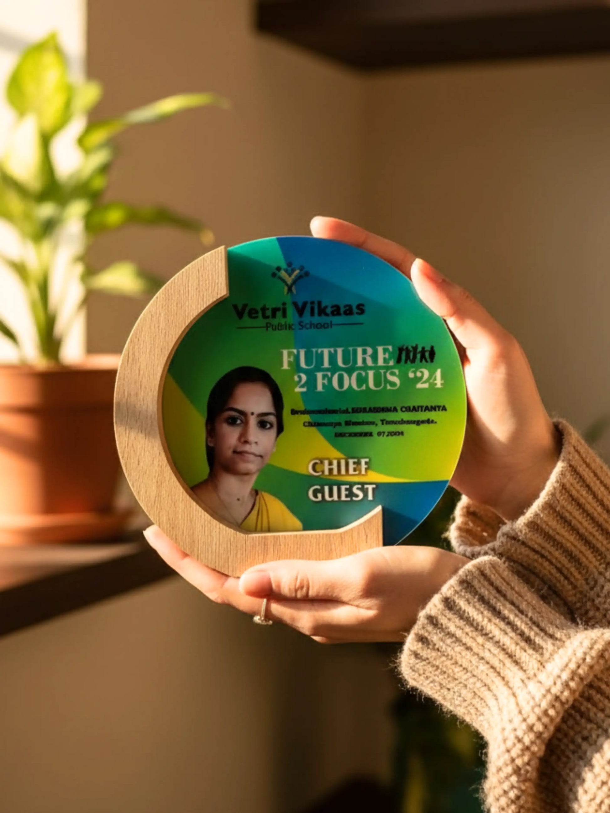 A sleek, golden trophy standing upright on a white background, highlighting its elegant curves and engravings.