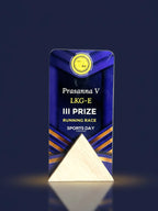 Decorative award with 'Prasanna V LKG-E III Prize Running Race Sports Day' text on a dark background