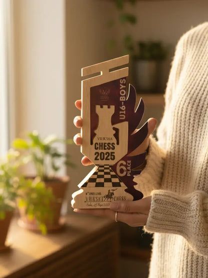 Person holding a chess-themed trophy with 'Vikram Chess 2025' branding
