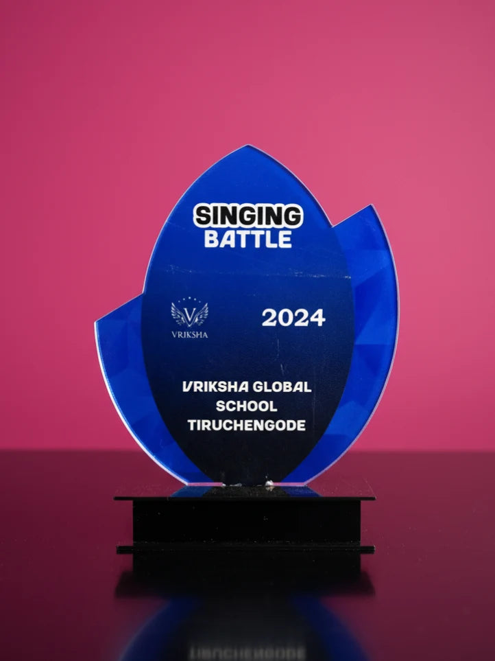 Blue trophy with 'Singing Battle 2024' and 'Vriksha Global School Tiruchengode' text on a pink background