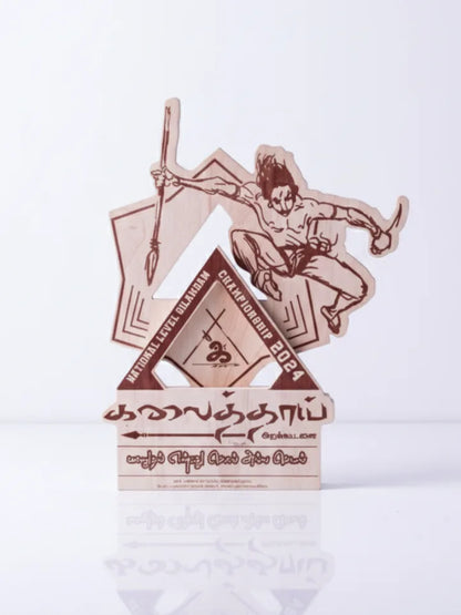 Decorative item with a design of a person sitting on a mountain, holding a sword, on a white background.