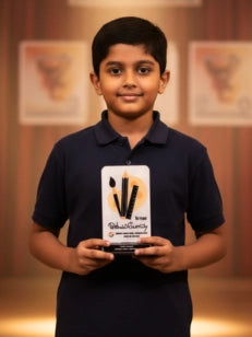 Young boy holding an award with a blurred background