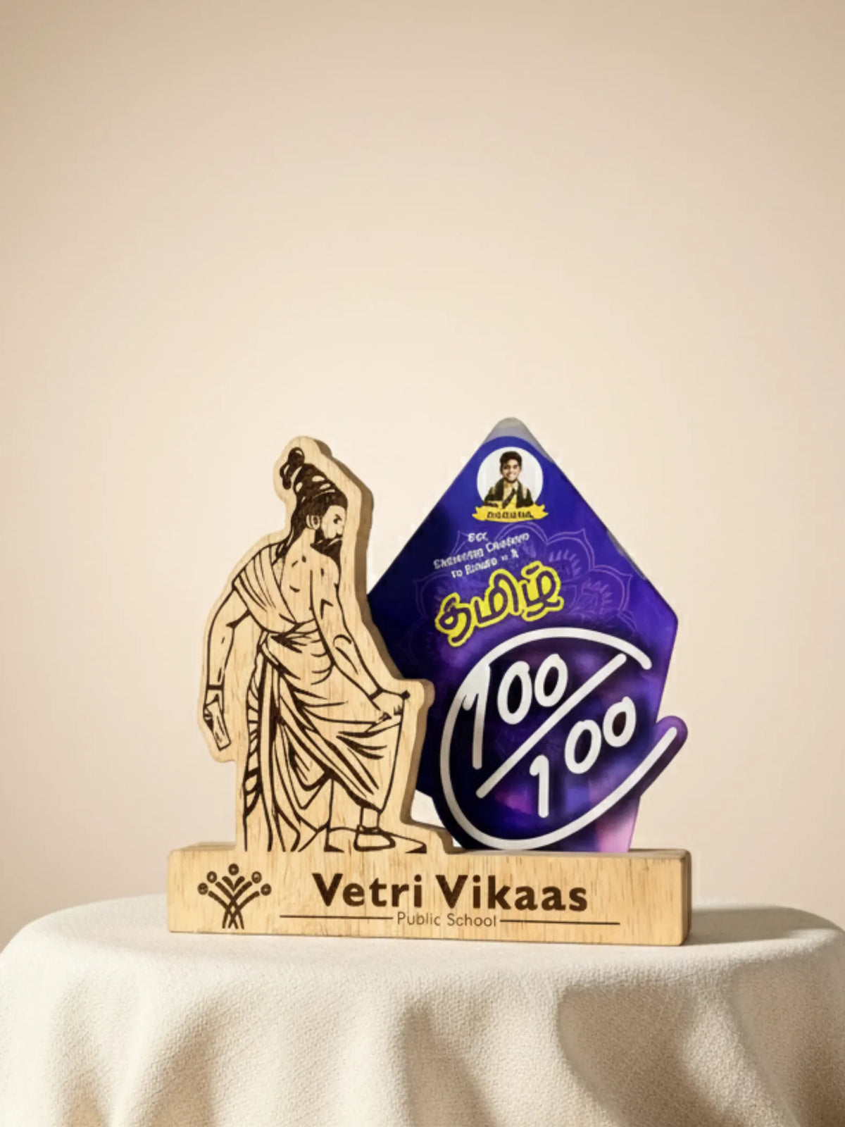 Decorative school award with a purple and blue design and wooden figure on a beige background