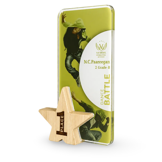 Decorative star-shaped award with a green and white rectangular plaque featuring a dancer.