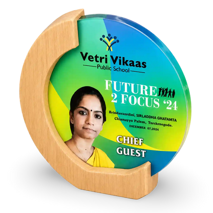 Decorative plate with a wooden stand featuring 'Vetri Vikaas Public School' and 'Future 2 Focus 24' text.