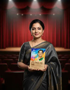 Woman in a black saree holding a plaque with a colorful design against a red curtain backdrop