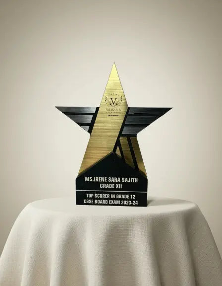 Star-shaped award with engraved text on a white surface