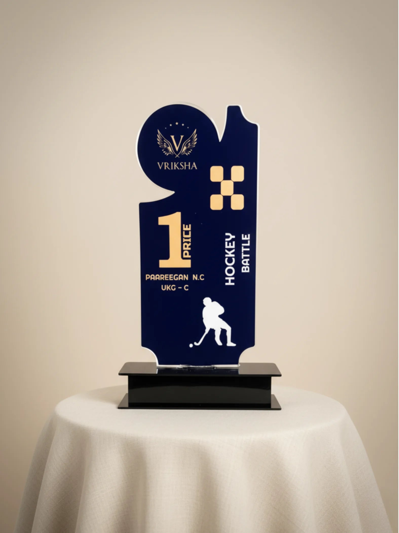 Navy blue trophy with gold accents on a beige background