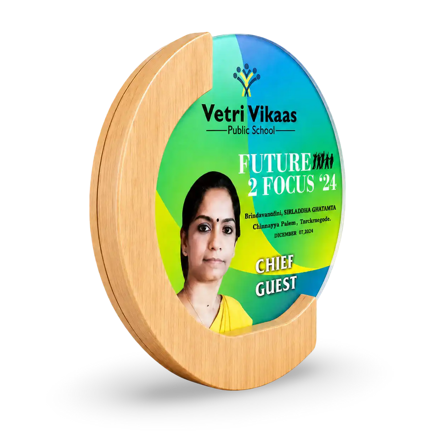 Round wooden plaque with a photo of a woman and 'Vetri Vikaas Public School' branding on a white background