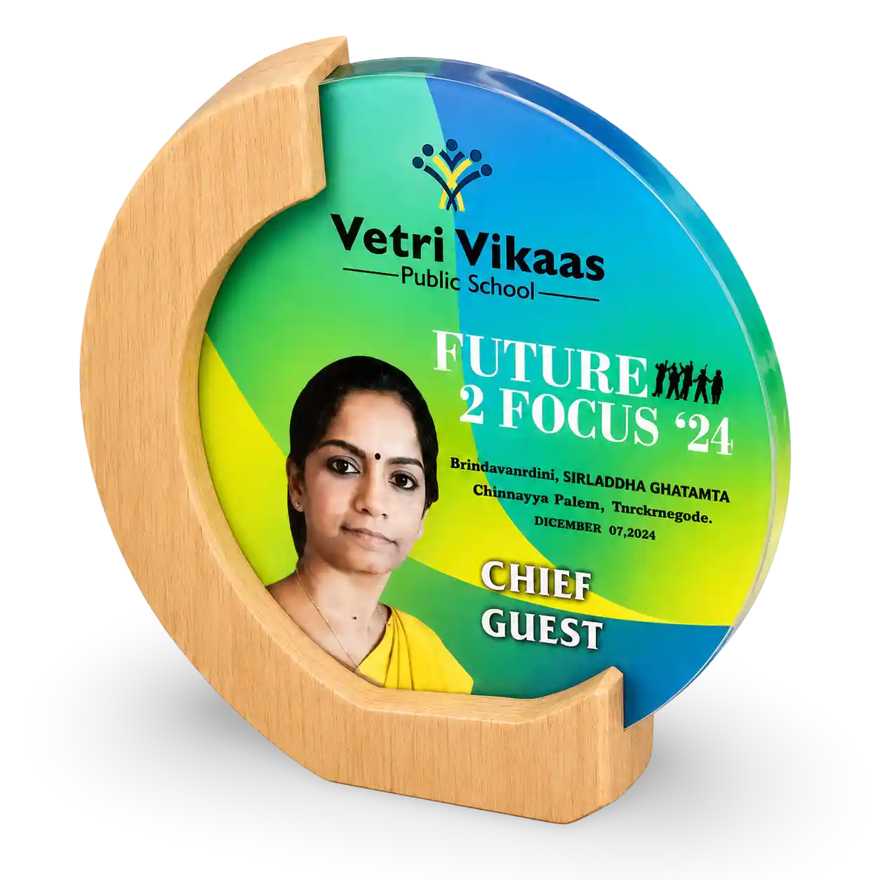 Decorative plate with a wooden stand featuring 'Vetri Vikaas Public School' and 'Future 2 Focus 24' text.