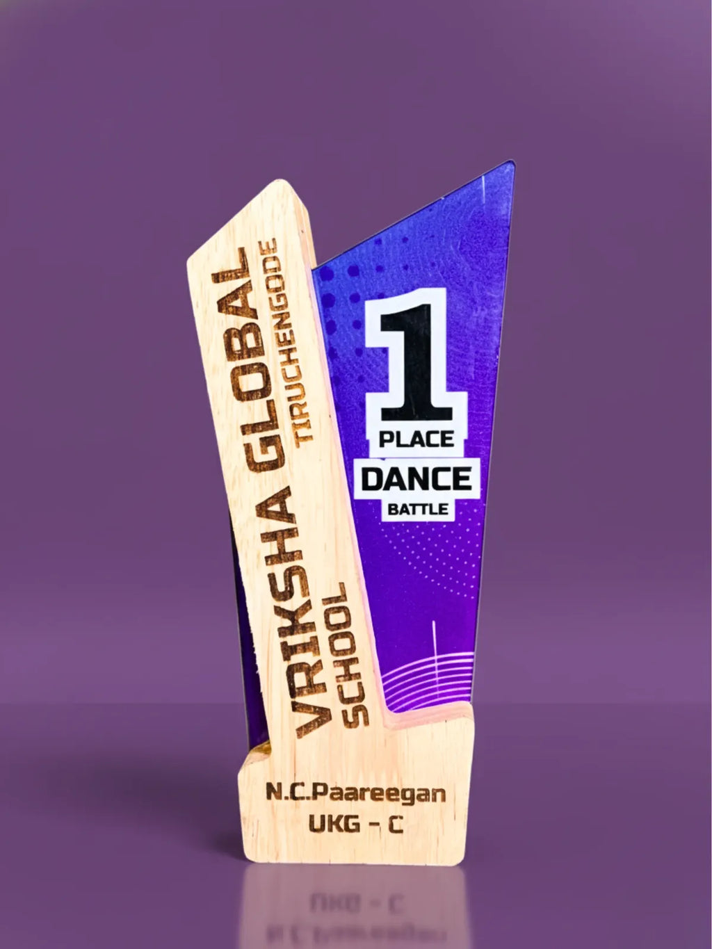 Wooden award with 'Vriksha Global' and '1 Place Dance Battle' text on a purple background