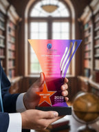 Person holding a colorful award in a library setting