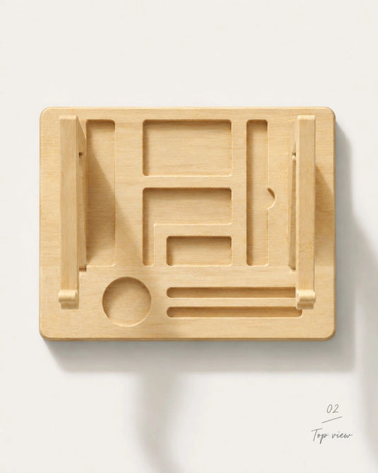 A light natural wood geometric wall-mounted shelf or tray with carved recesses and small hanging loops, shown from above on a white background.