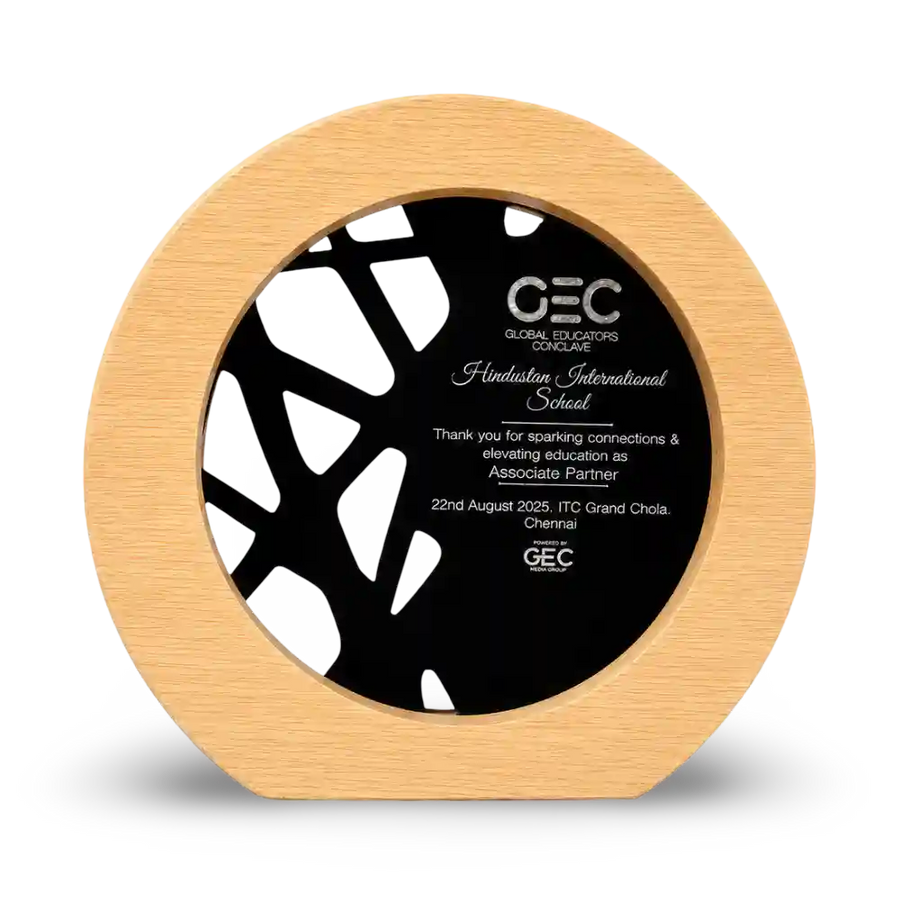 Wooden circular award with black center displaying text and GEC logo
