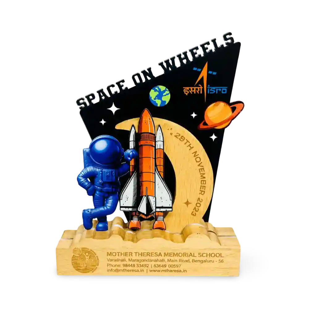 A custom wooden school memorial trophy featuring a blue astronaut, an orange and white rocket, a black starry background with 'SPACE ON WHEELS' 