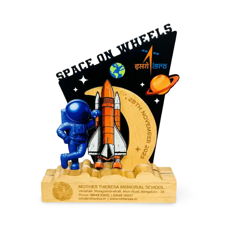 A custom wooden school memorial trophy featuring a blue astronaut, an orange and white rocket, a black starry background with 'SPACE ON WHEELS' 