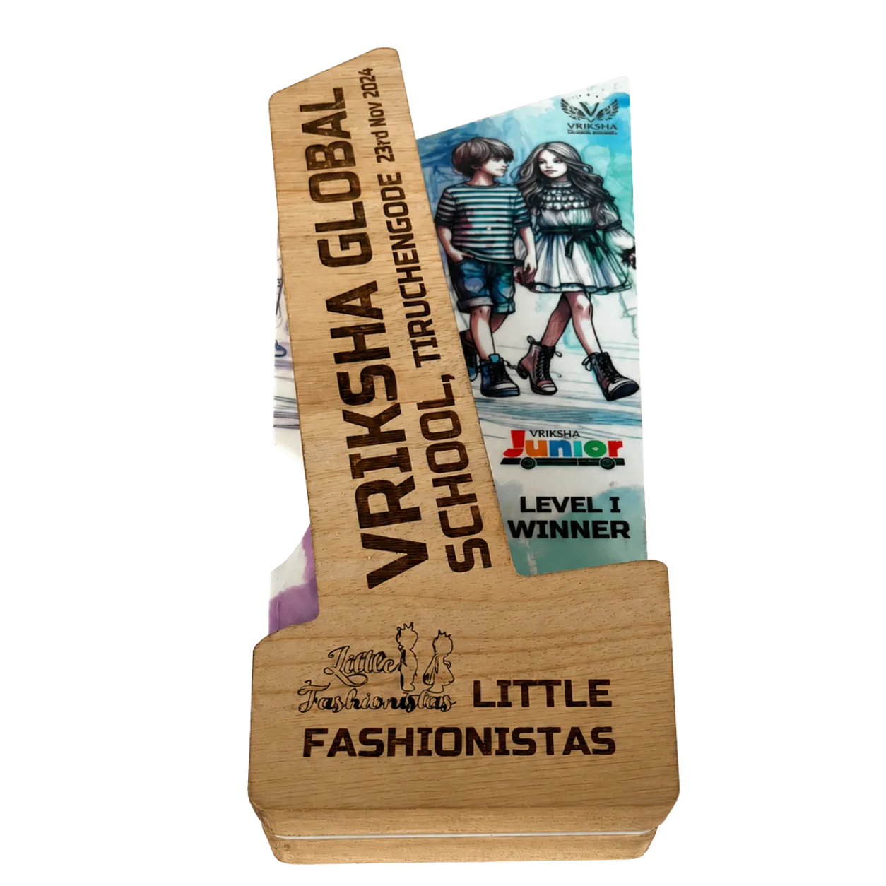 Wooden award with engraved text and a magazine on a white background