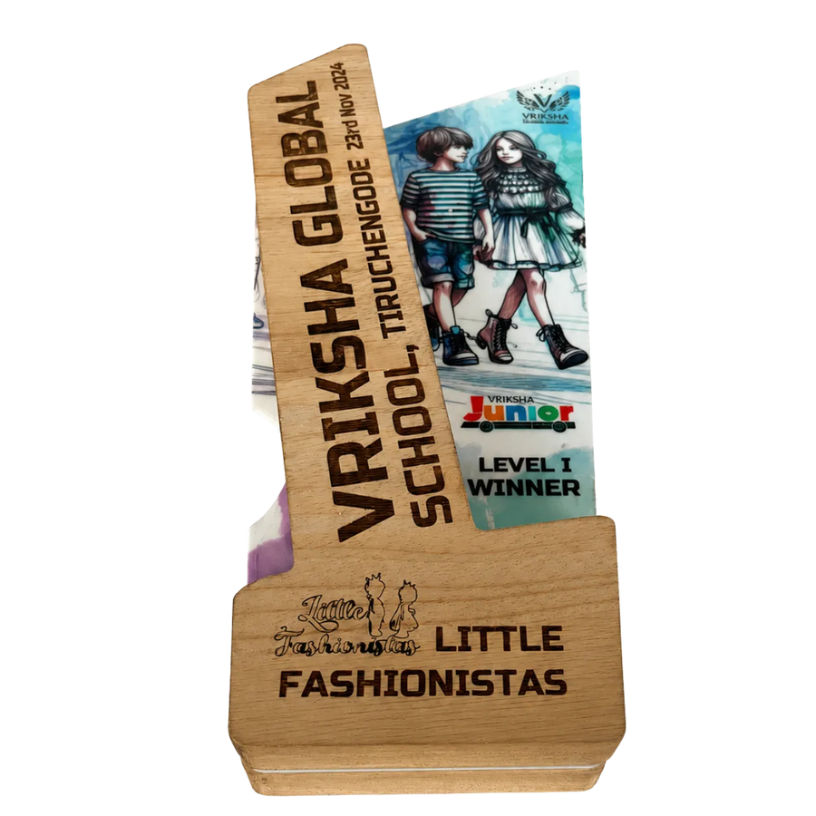 Wooden award with engraved text and a magazine on a white background