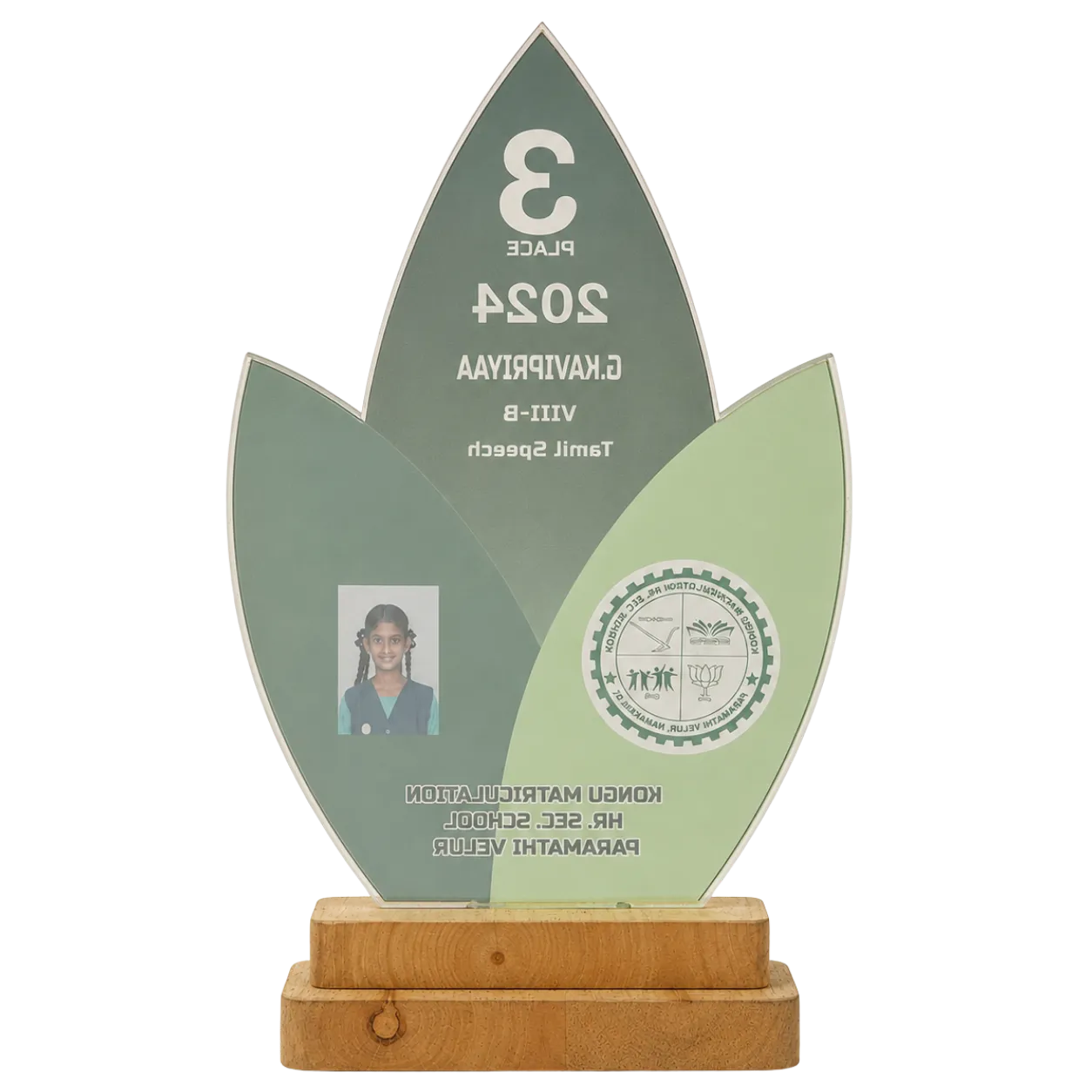 Decorative award with green leaf design, wooden base, and photo of a person.