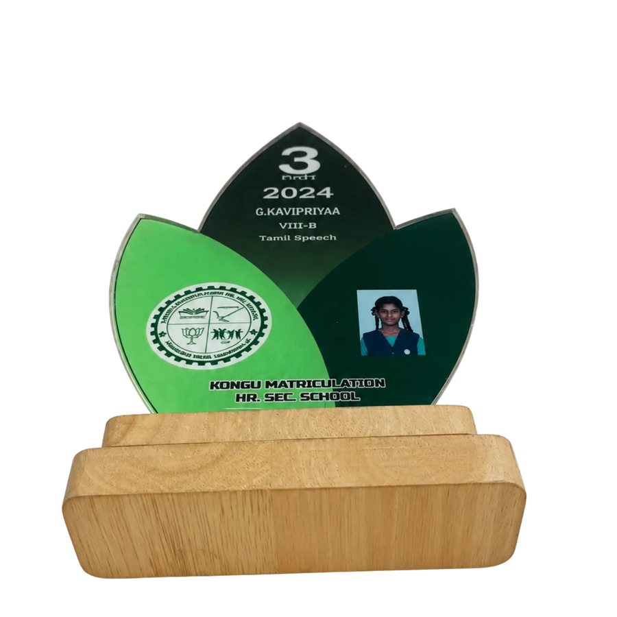 A green and black award with a wooden base on a white background